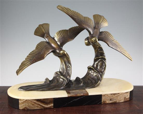 H. Molins. An Art Deco bronze group of two seabirds flying over waves, W.22in. H.16in.